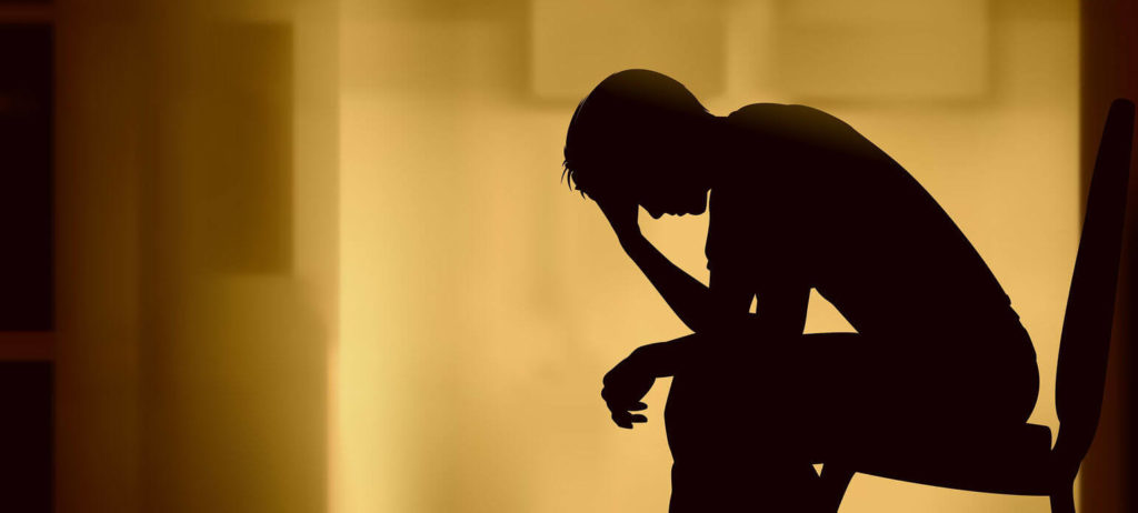Silhouette of person grieving